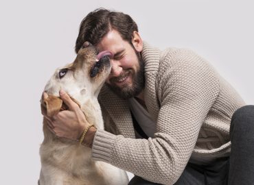 dog licking a smiling man