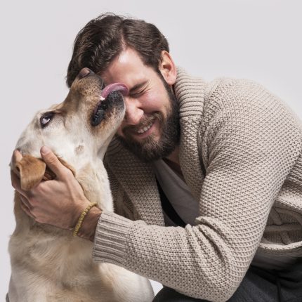 dog licking a smiling man