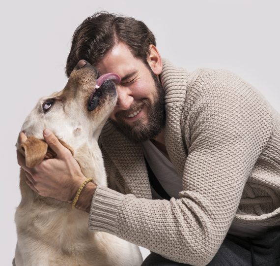 dog licking a smiling man